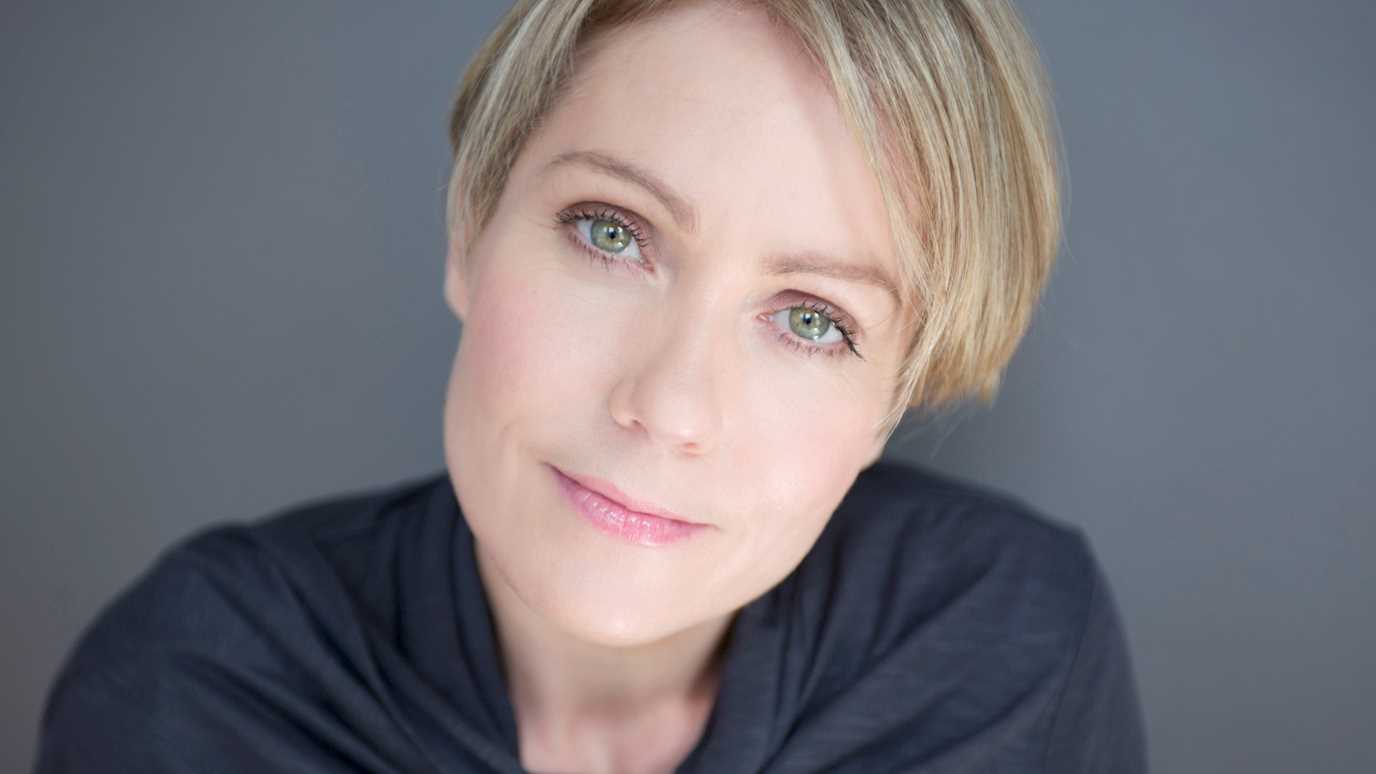Emily Saunders blue top head tilt.jpg