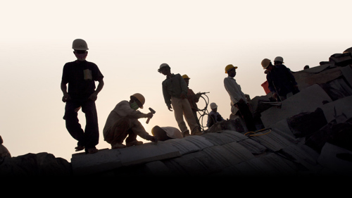 Silhouette of construction workers on a building in Cambodia