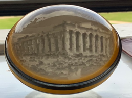 A circular object with a building in the middle
Description automatically generated
