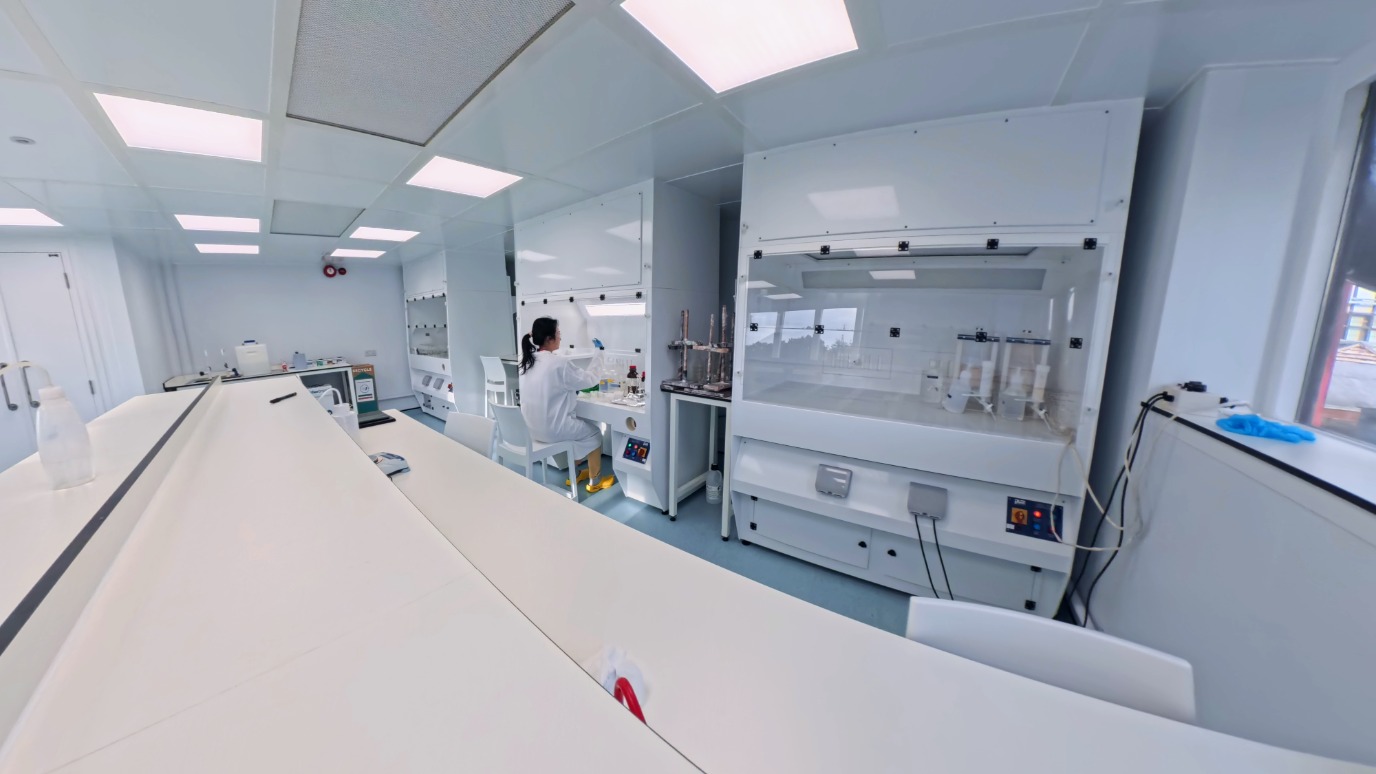 Wide angle view of the lab with Queenie sitting working 