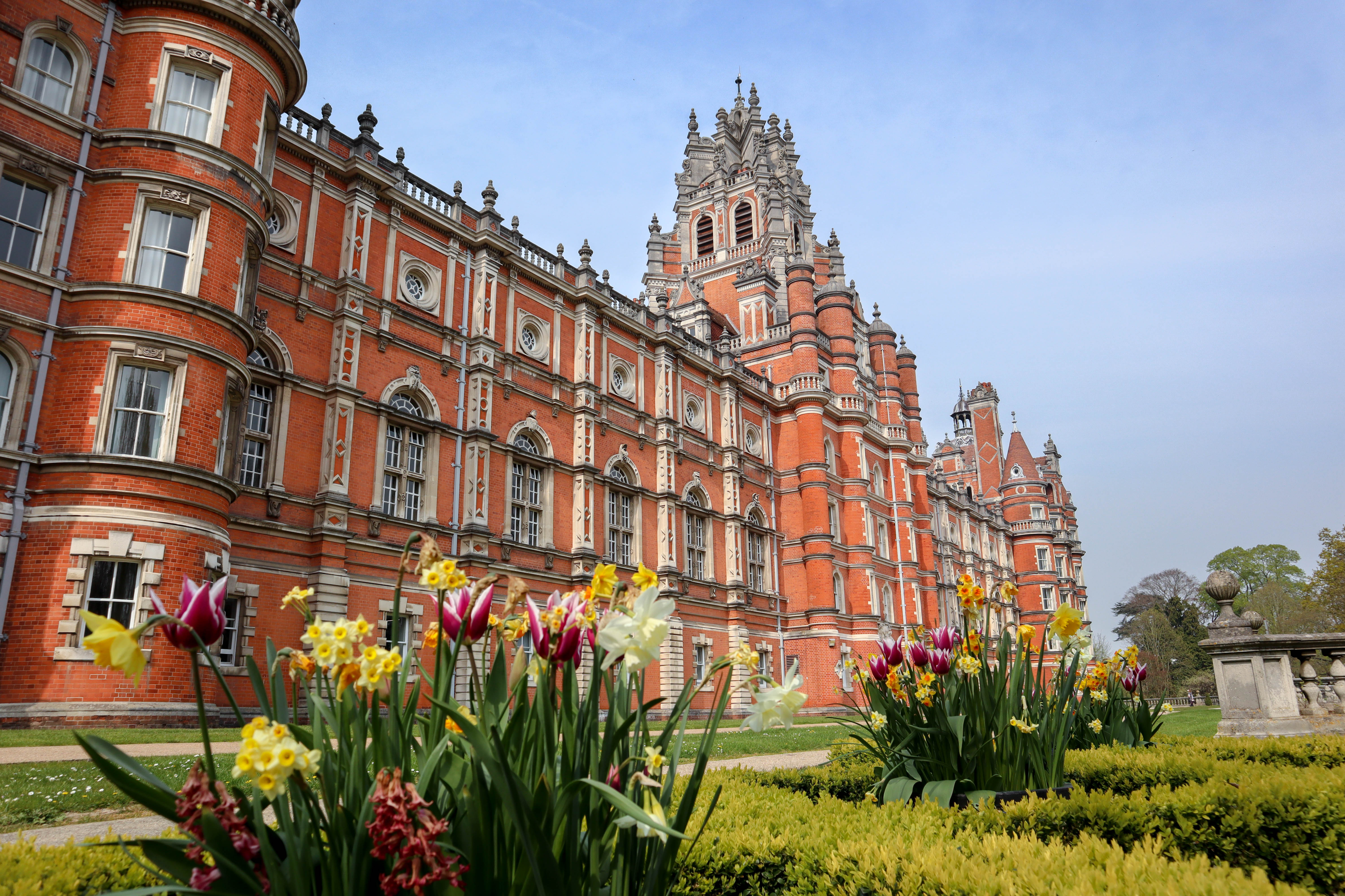 Spring flowers in bloom in front of the Founder's Building on Royal Holloway's Egham campus